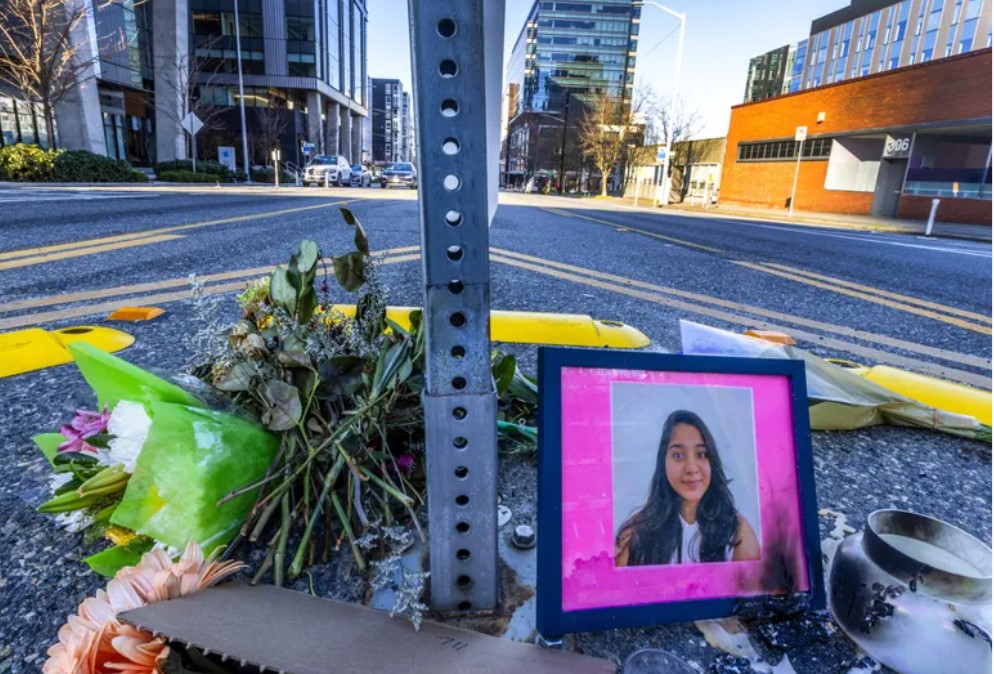 Flowers and a photo of Jaahnavi Kandula lie at a memorial to the young woman in South Lake Union. Kandula was killed on Jan. 23, 2023, by a Seattle police officer who was driving 74 mph. (Ken Lambert / The Seattle Times, 2023)